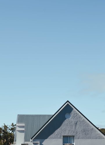 house with metal roof set against a blue sky