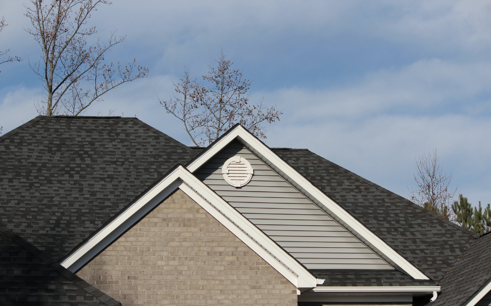 Close-up view of a house roof with dark asphalt shingles