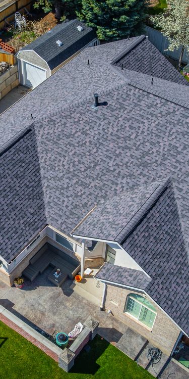 Aerial view of a residential roof with Duration shingles in varying purple tones.