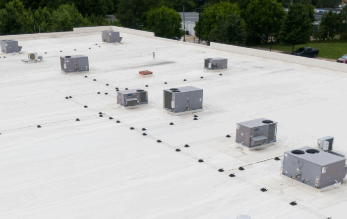 White single-ply commercial roof with multiple HVAC units on top, showcasing a clean and efficient membrane installation ideal for TPO or PVC roofing systems.